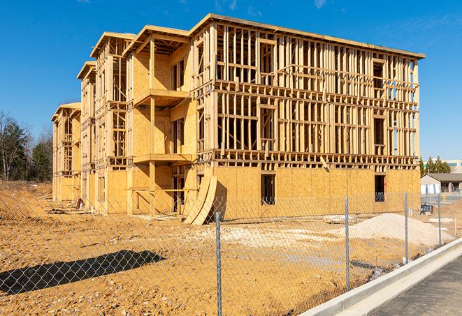 a close-up of temporary chain link fences enclosing a job site, signaling progress in the project's development in El Monte